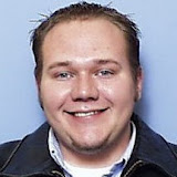 My hunny's badge picture from TheBay.  Their camera makes you look like a felon.  (2004)