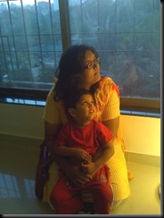 Arjun and Nitya looking at the floor lamp