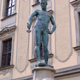 This naked guy apparently lost all of his clothes after losing a card game.  Poor guy's sword is all bent too.  Tough luck.