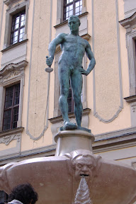 This naked guy apparently lost all of his clothes after losing a card game.  Poor guy's sword is all bent too.  Tough luck.