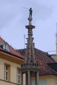 This is the flogging post outside the town hall.  Petty thieves were tied to it, and beaten - hence the little guy on top.