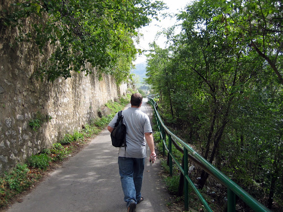 Carey walking along a fortified hills wall