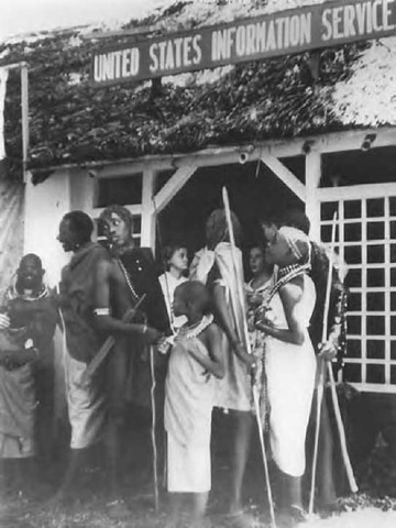 The USIA (known overseas as USIS) took pains to reach rural populations in the Third World during the Cold War. Here Masai people in Kenya wait in line to view a USIA exhibit on agriculture in 1957.