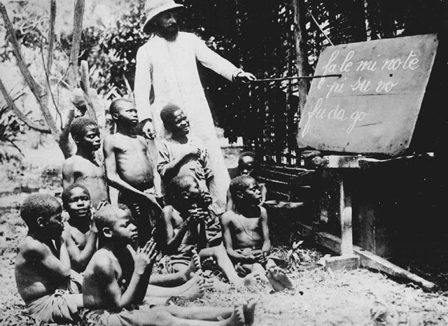 Reading Lesson in the Congo. A class of boys learns to read the local language in 1930 at the Jesuit school of Kwango in the Belgian Congo. 