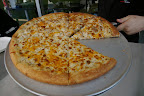 They were selling pizza outside Fresh Slice. Their pizza effin' sucks.  The guys workin' there, however, were very nice. I was taking a picture of the pizza under the display case (with the above caption in mind) when the manager said "Pull it out and put it on top so he can get a good picture to capture how good it is!"