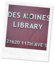 Wheelie and Des Moines Sign