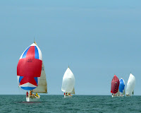 2009 Race Events / Colors 2009 Race 2:  As the sun finally breaks out late on Saturday, the 40.7's are in the final leg of the last race of the day.  (L-R) Spanker, La Tempete, Excalibur, Cancan.  (white spinnaker at right is not a 40.7)