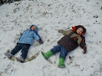 J and Daniel making snow angels
