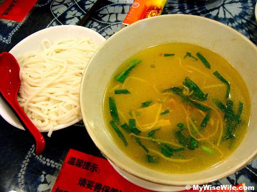 Pre-cooked rice noodles and a bowl of very hot soup