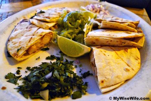 Chicken Pirata and jack cheese in toasted flour tortillas served with guacamole, red onion and cilantro. Chicken Pirata and jack cheese in toasted flour tortillas served with guacamole, red onion and cilantro.