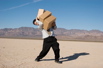 Businessman carrying boxes