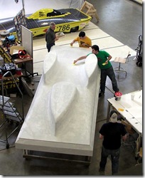 Abraham Poot, Nick Killoran, and Joe Mydosh work on the Sunseeker body