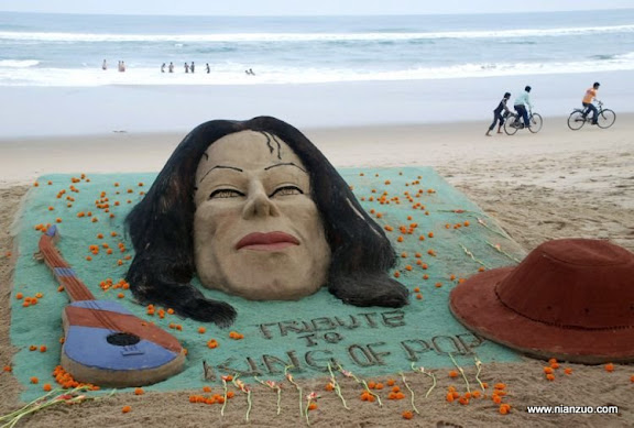 关于杰克逊 Sand sculptures of Michael Jackson, a guitar and his fedora hat, made by Sudarshan Pattnaik are seen at the golden sea beach for the fans to pay floral tribute to the 