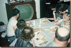 family at dinner with tv