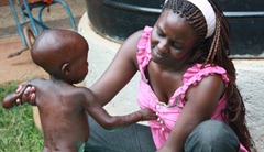 Nsambya volunteer bathing the nameless boy