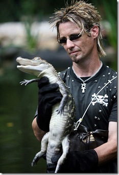 Network: A&E Network 
Program: The Exterminators 
Caption: Billy Bretherton, Vexcon exterminator, holds up a baby alligator in the swamps of Louisiana before releasing it back into the wild, and far away from his clients’ homes in A&E’s “The Exterminators.”  
Credit: Scott Gries  