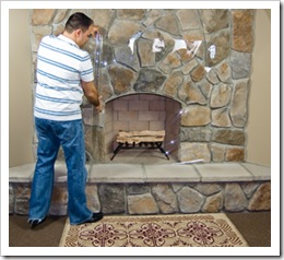 Unrolling the plastic over the fireplace