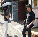 Host mom and brother waiting at bus stop.