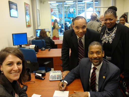 ERDA FCU CEO Carmen Simon and Bishop Mitchell Taylor open a credit union account for New York City Housing Authority Chairman John Rhea.