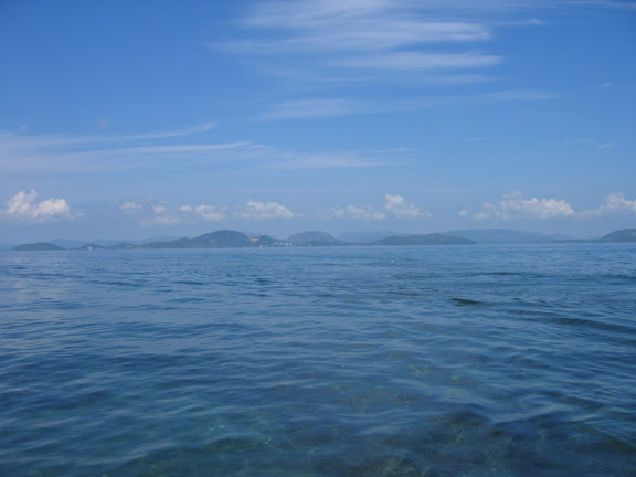 a body of water with islands in the background