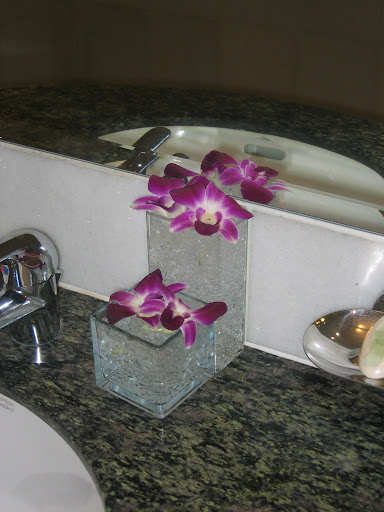 purple flowers in a glass vase on a counter top