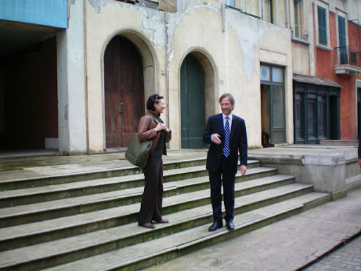 a man and woman standing on steps