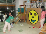 Sophy scoring big points at the bean bag toss, run by Sandy and Daphne