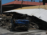 destroyed truck and building in Taimali