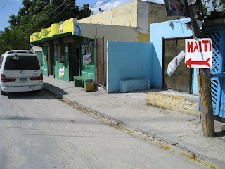 On our way to Jimani with a team of 8 to help earthquake victims. This is a random town with a store that had a toilet.