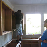 Installing the upper cabinets.