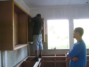 Installing the upper cabinets.