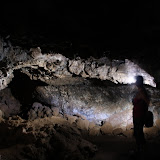 Amy explores the cave with a headlamp
