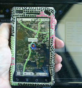 Hand holding cell phone with map on screen