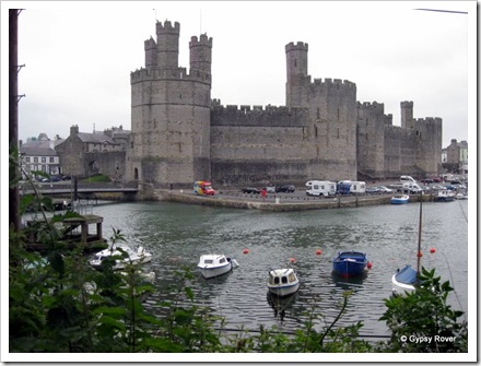 Caernarfon Castle and the harbour at high tide.
