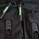 The metal zippers are hidden behind rubber caps so that they don't flap around. The other zippers have reflective thread running through them for better visibility