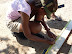 Zoey measuring and marking for the treehouse floor frame.
