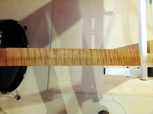 This is what a roasted curly maple fretboard looks like with a thin coat of sealer on it. Zowie!