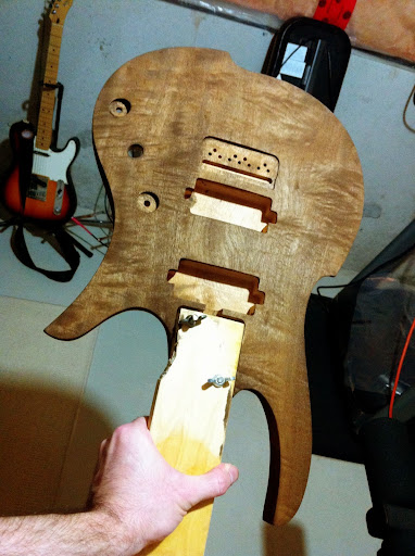 The first shot of dye rubbed into the figured mahogany body. Sort of a "mocha espresso" brown. Left to dry overnight.