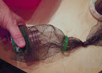 Securing the net to the bottle top.