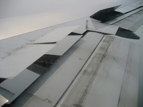 Flaps extended and spoilers up to cut lift.