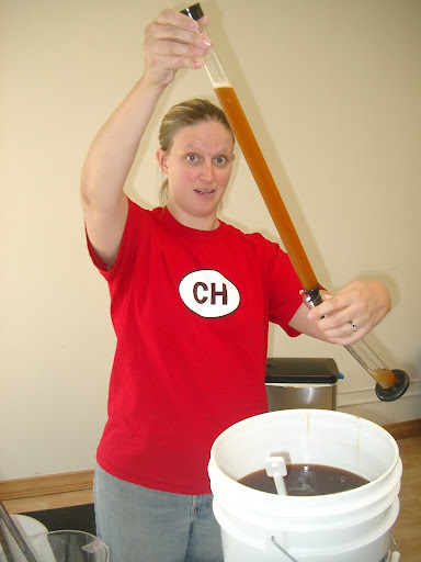 Me using the beer thief to put wort into our hygrometer for measuring specific gravity.  