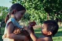 Mariah and Carlos (my sister and brother) play with one of our chickens. We always had hens mainly for their eggs, my parents still keep four or five even though they don't go through as many eggs with the kids out of the house. Mariah and Carlos (my sister and brother) play with one of our chickens. We always had hens mainly for their eggs, my parents still keep four or five even though they don't go through as many eggs with the kids out of the house.