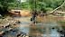 Bikers line up to cross the second stream which is deeper!