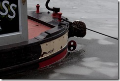 the canals frozen except for small footprints around the boats