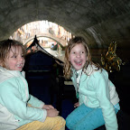 We seek refuge under a pedestrian bridge in the downpour.