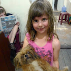Emma reads the English language local paper, and lily plays with the doggie.