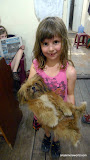 Emma reads the English language local paper, and lily plays with the doggie.