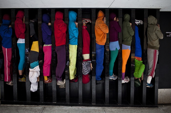 Performers situate themselves into position during a piece entitled "Bodies in Urban Spaces" by choreographer Willi Dorner.  Starting at sunrise, the performers inched their way into different spaces throughout lower Manhattan.CREDIT: Bryan Derballa for The Wall Street JournalNYBODIES