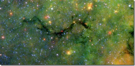 This infrared image from NASA's Spitzer Space Telescope shows what astronomers are referring to as a "snake" (upper left) and its surrounding stormy environment. The sinuous object is actually the core of a thick, sooty cloud large enough to swallow dozens of solar systems. In fact, astronomers say the "snake's belly" may be harboring beastly stars in the process of forming. <br /><br /><br />The galactic creepy crawler to the right of the snake is another thick cloud core, in which additional burgeoning massive stars might be lurking. The colorful regions below the two cloud cores are less dense cloud material, in which dust has been heated by starlight and glows with infrared light. Yellow and orange dots throughout the image are monstrous developing stars; the red star on the "belly" of the snake is 20 to 50 times as massive as our sun. The blue dots are foreground stars. <br /><br />The red ball at the bottom left is a "supernova remnant," the remains of massive star that died in a fiery blast. Astronomers speculate that radiation and winds from the star before it died, in addition to a shock wave created when it exploded, might have played a role in creating the snake.<br /><br />Spitzer was able to spot the two black cloud cores using its heat-seeking infrared vision. The objects are hiding in the dusty plane of our Milky Way galaxy, invisible to optical telescopes. Because their heat, or infrared light, can sneak through the dust, they first showed up in infrared images from past missions. The cloud cores are so thick with dust that if you were to somehow transport yourself into the middle of them, you would see nothing but black, not even a star in the sky. Now, that's spooky!<br /><br />Spitzer's new view of the region provides the best look yet at the massive embryonic stars hiding inside the snake. Astronomers say these observations will ultimately help them better understand how massive stars form. By studying the clustering and range of masses of the stellar embryos, they hope to determine if the 