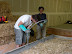 Plaster is poured and vibrated down the sides of the forms to meet up with the embedded window stud